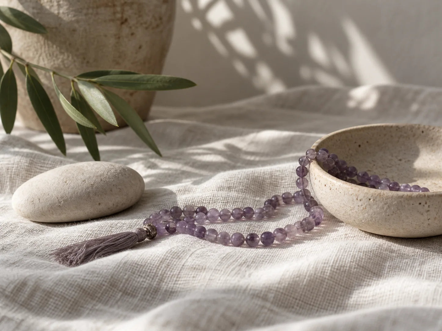 Mala beads arranged in a calm natural setting